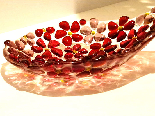 Pink fused glass spoon rest in ditsy flower design . Close up of spoon