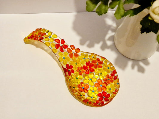 Yellow and orange fused glass spoon rest in ditsy flower design. Top view